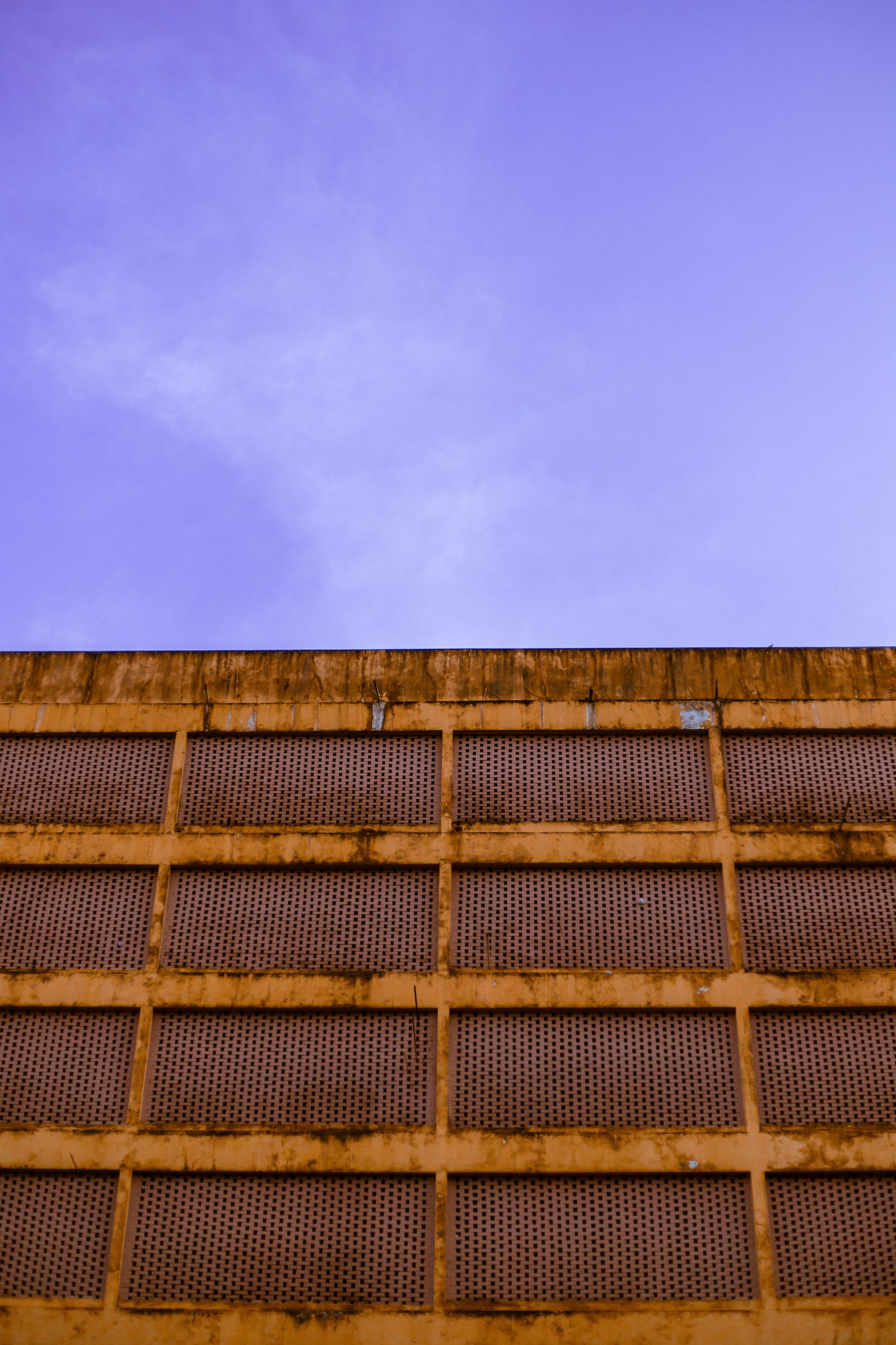 Textured concrete facade exposed to direct sun